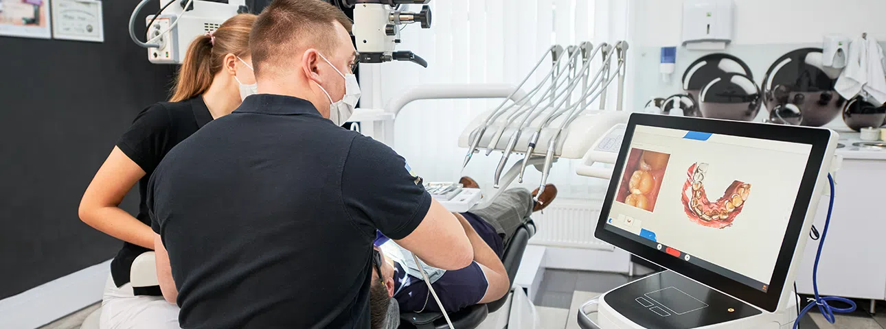 Dentist using CEREC technology to install dental crowns and bridges.